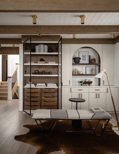 A modern living room with wooden floors and a cowhide rug.